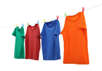 Colorful t-shirts drying on washing line isolated on white
