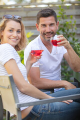woman and man in vineyard drinking wine