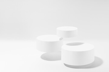 Three levitate white round podiums in hard light, shadow, mockup on white background. Template for presentation cosmetic products, gifts, goods, advertising, design, display, showing in simple style.