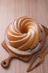 A very delicious and tempting cake served with powdered sugar and fruit