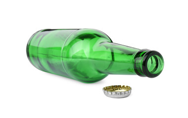 One empty green beer bottle and cap isolated on white