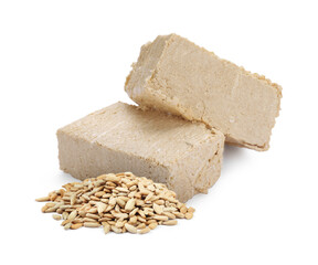 Tasty halva and peeled sunflower seeds isolated on white