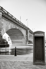black and white london bridge telephone booth on the river
