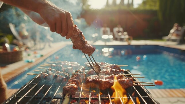 A male making barbecue at poolside party with family in backyard.