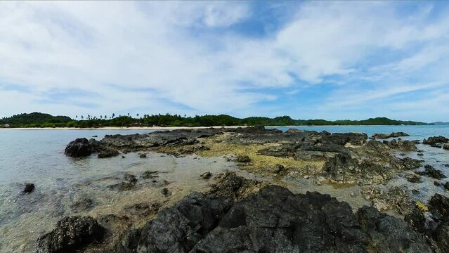 Rocks with ocean waves in coastal area in Santa Fe, Tablas Island. Romblon, Philippines.