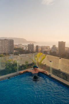 Cool man in the pool at sunset in Lima Peru
