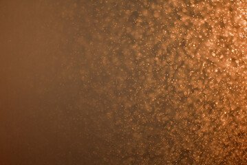 Abstract orange-brown background with bright splashes and light gradient