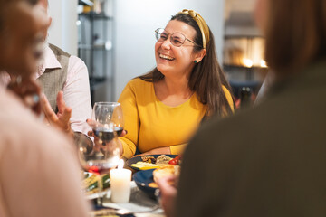 Happy Woman Laughing with Friends at Dinner