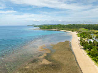 Tropical beach resort with white sand and clear sea water with corals. Santa Fe, Tablas, Romblon. Philippines.