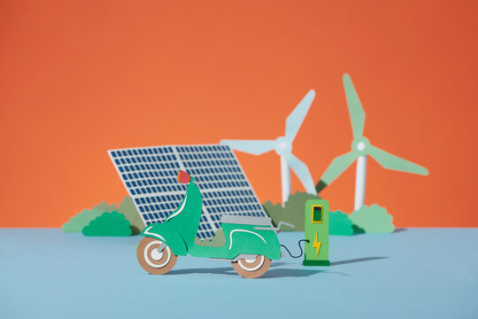 Electric car with charger stand, solar panel and wind