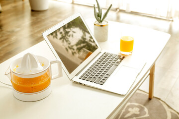 Scene with freshly squeezed juice and laptop