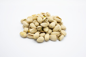 A small pile of Pistachio Nuts isolated on a white background.

