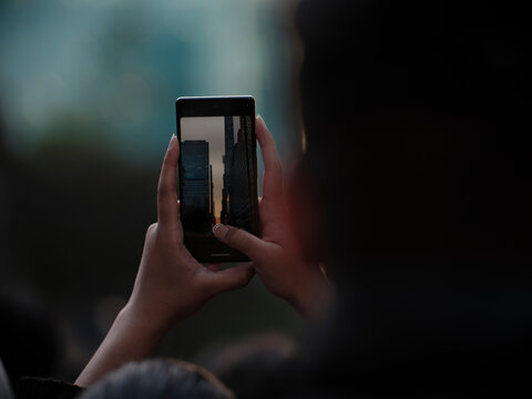 Manhattan henge hand holding a phone