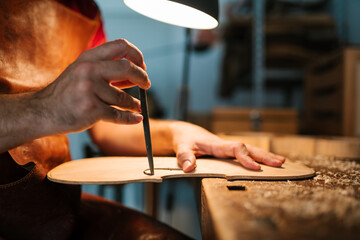 Crop craftsman painstaking violin with chisel