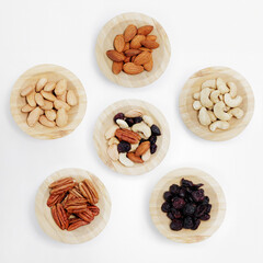 healthy food - set of wooden bowls of nuts on white background