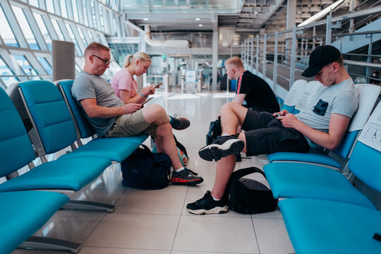 Family waiting in an airport departure lounge.