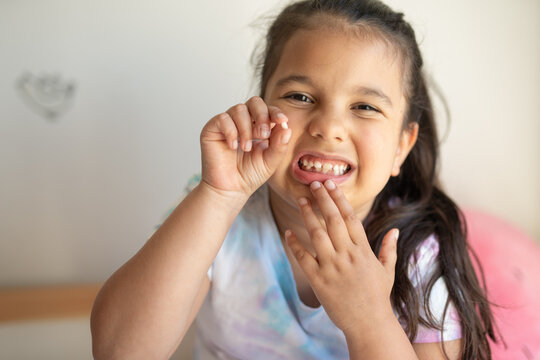 Girl showing her recently lost tooth 