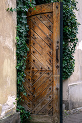 Beautiful old wooden door with iron ornaments in the old town. - 751220254