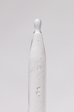 macro image of clear serum dripping out of dropper