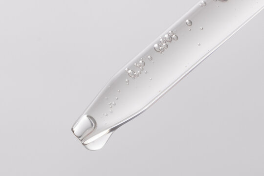 macro image of clear serum dripping out of dropper