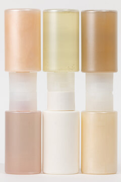 symmetrical stack of beauty packaging in warm pastel tones