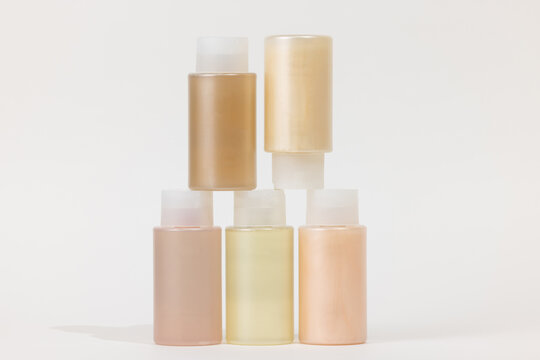 stack of beauty packaging in warm pastel tones