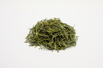 Dry green tea leaves on a white background. Tea leaves on a white background.