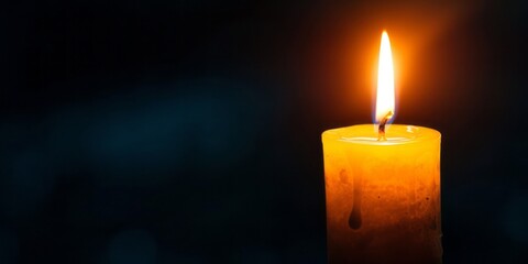 A single candle burning brightly in a dark room, with space for a message of hope or remembrance