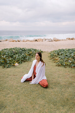 Woman Meditating On Sea Shore