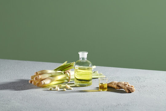 a glass transparent jar containing essential lemongrass oil