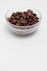 Choco cereals served in glass bowl on white background