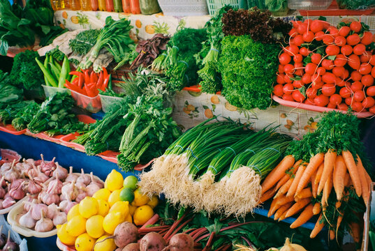 A counter with fresh vegetables and greens from the garden in summer