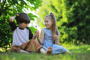 Children walk in the summer in nature. Child on a sunny spring morning in the park. Traveling with children.