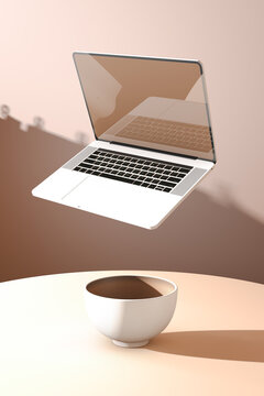 A laptop computer flying over a bowl of coffee