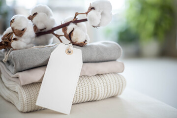 A neat stack of clean knitwear in neutral colors. Concept for sale, recycling and storage of...