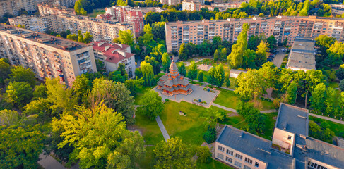 Colorful summer view of Khram Pokrovy Presvyatoyi Bohorodytsi church in the middle of a residential...