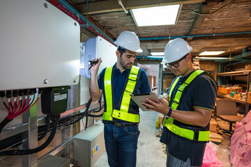 Service Engineer use tablet working inspection installation inverter solar cell. Technician...