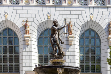 17th century Neptune's Fountain Statue at Long Market  Street by the entrance to Artus Court, Gdansk, Poland