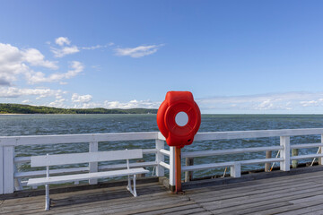 Red lifebuoy on the barrier of Sopot pier in the Gulf of Gdansk in the Baltic Sea, Sopot, Poland