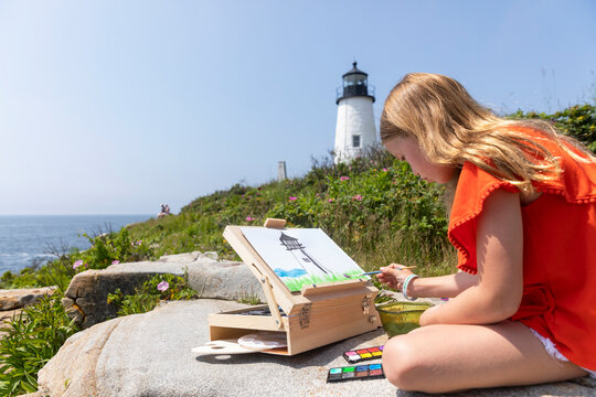 Young Girl focus Lighthouse on Coast of Maine Summer in New England 