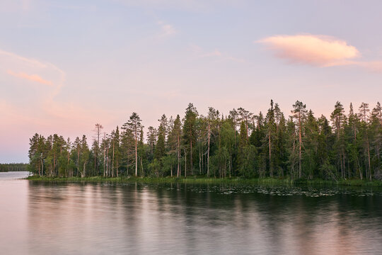 lake sunset photograph of a forest mirroring on the water