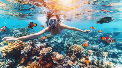 Schilderijen op glas woman snorkeling underwater with Nemo fishes in the coral reef Travel lifestyle, swim activity on a summer beach holiday in Thailand © Fokke Baarssen