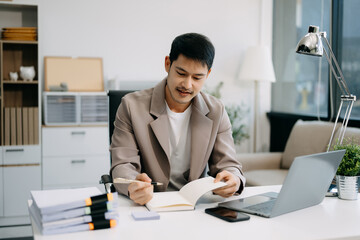 business man executive manager looking at laptop watching online webinar training or having virtual meeting video conference doing market research working .