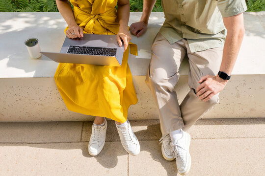 Two colleagues talking on the terrace of a modern corporate building 