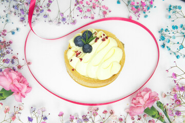 Cookies surrounded by colorful small flowers.