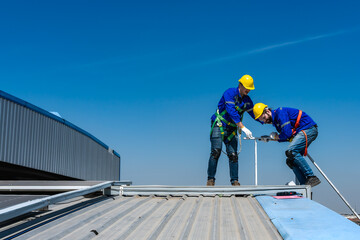 Roofer man helping hands to climbing on roof, work on height concept