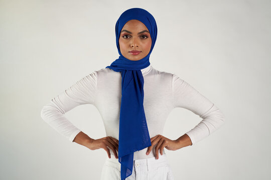 Studio portrait of woman in blue headscarf and white top