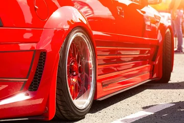 Deurstickers Red Sports Tuned Car Rear View Wheel Close Up Fashion Car Day Road 2 © Raima