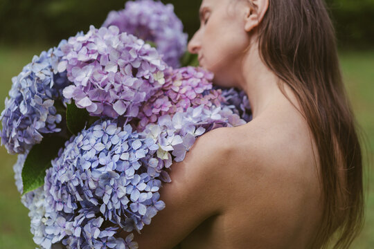 Young woman with bouquet hydrangea flowers