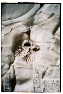 Pair of baby booties and newborn clothes